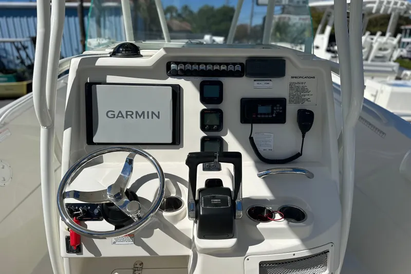 Slide: The Image of 2015 Sailfish 240 CC boat dashboard with Garmin navigation system and controls. - 12