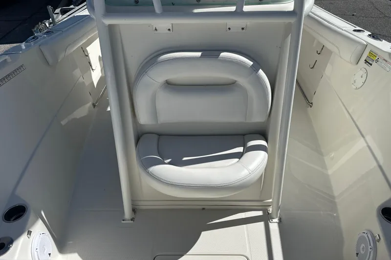 Slide: The Image of 2015 Sailfish 240 CC boat interior with white cushioned seating. - 13