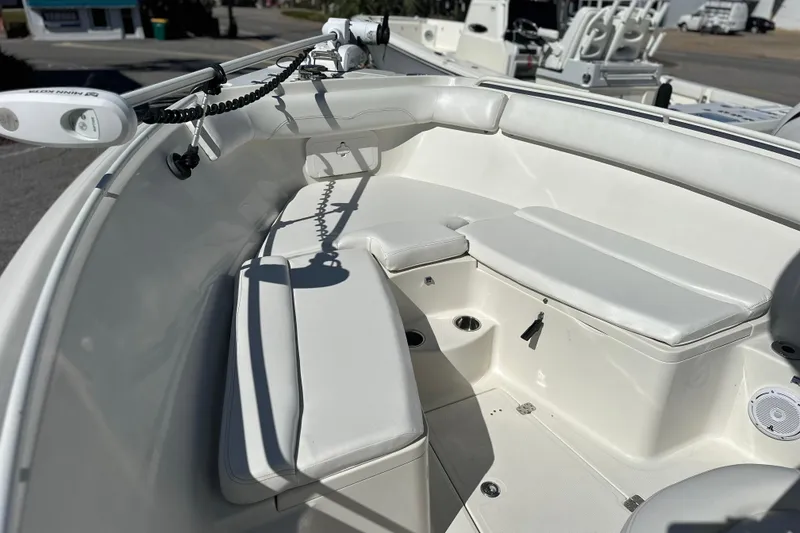 Slide: The Image of 2015 Sailfish 240 CC boat interior with white cushioned seating and fishing equipment. - 14