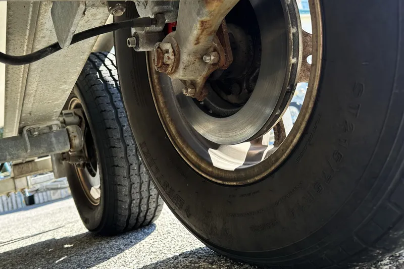 Slide: The Image of Close-up of a 2015 Sailfish 240 CC trailer wheel and brake disc. - 17