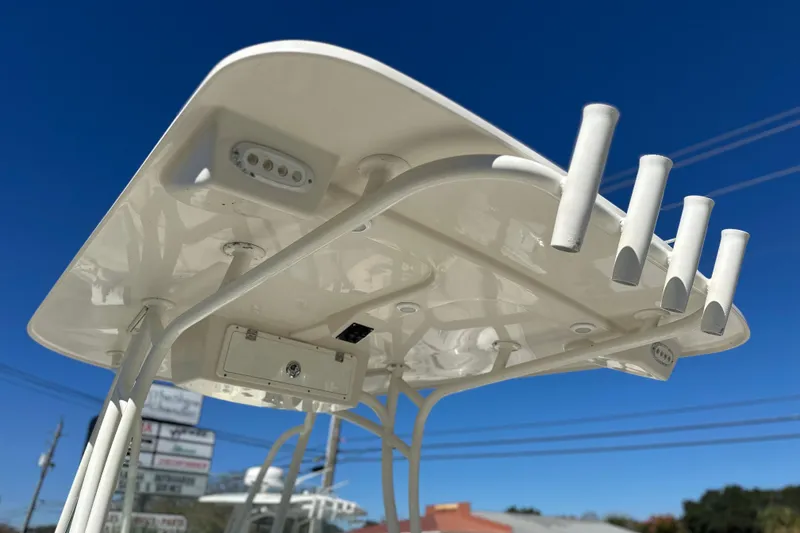 Slide: The Image of 2015 Sailfish 240 CC boat's T-top with rod holders against clear blue sky. - 4