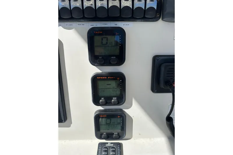 Slide: The Image of Control panel of 2015 Sailfish 240 CC boat with digital displays and switches. - 7
