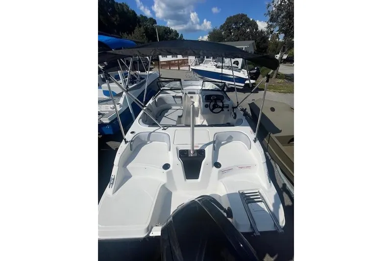 Slide: The Image of 2026 Bayliner M17 boat with canopy, spacious seating, and modern design. - 17