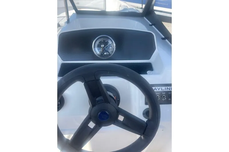 Slide: The Image of 2026 Bayliner M17 boat dashboard with steering wheel and gauge. - 9