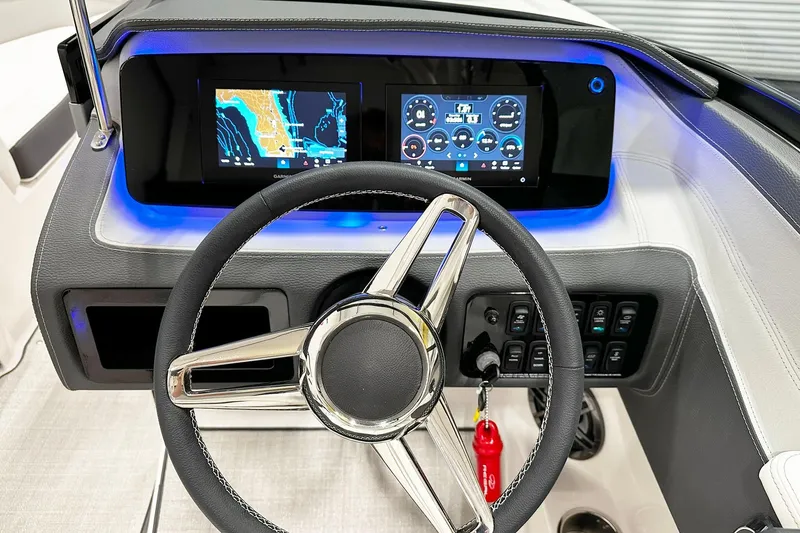 Slide: The Image of Steering wheel and digital dashboard of 2025 Regal LS2 boat, featuring navigation displays. - 6
