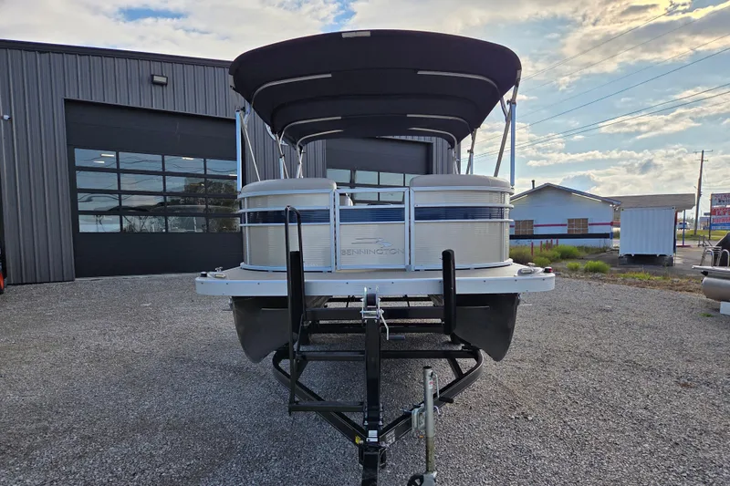 Slide: The Image of 2017 Bennington 22 SSRX pontoon boat on trailer, parked outside a garage. - 4