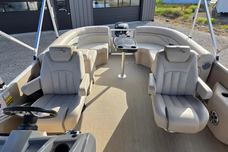 Slide: The Image of 2017 Bennington 22 SSRX pontoon boat interior with plush seating and table. - 7