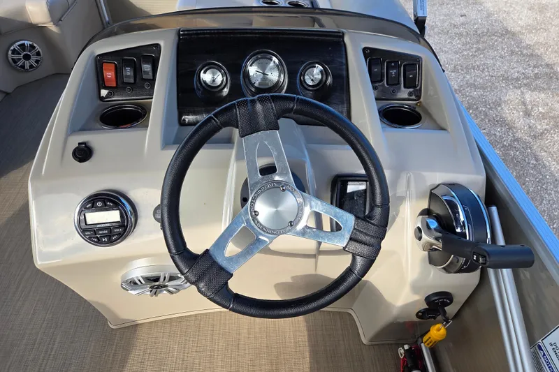 Slide: The Image of Steering console of a 2017 Bennington 22 SSRX boat with controls and gauges. - 8