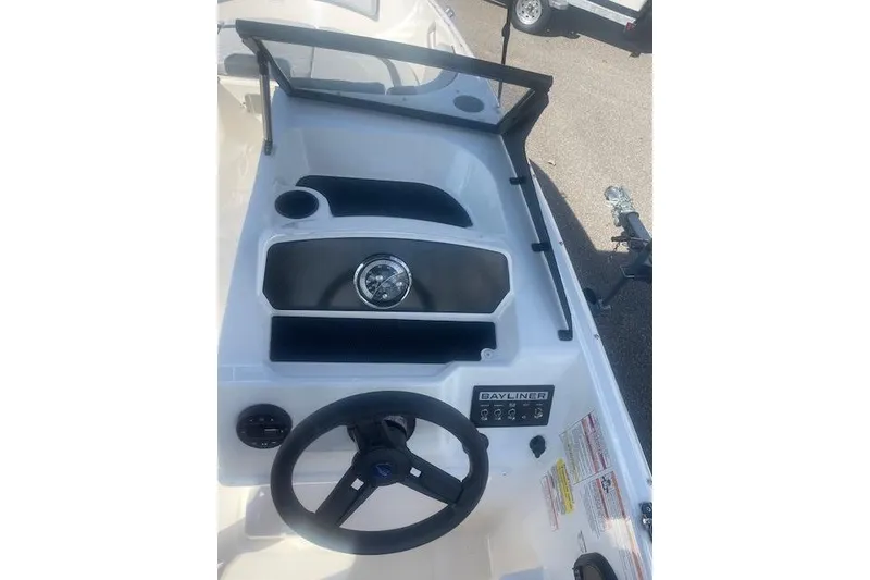 Slide: The Image of 2026 Bayliner M17 boat dashboard with steering wheel and control panel. - 4