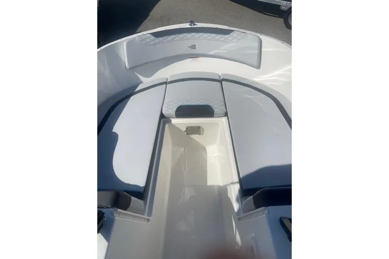 Slide: The Image of 2026 Bayliner M17 boat interior with cushioned seating and storage area. - 6