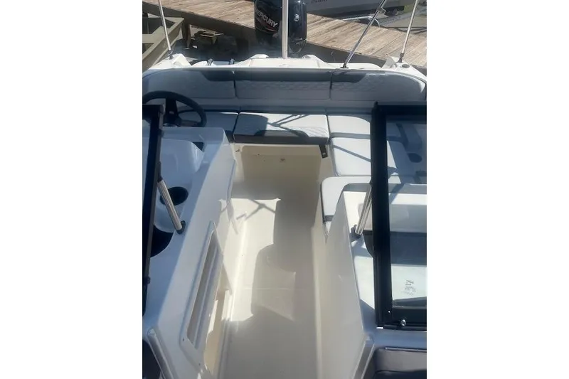 Slide: The Image of 2026 Bayliner M17 boat interior with seating and steering wheel. - 7