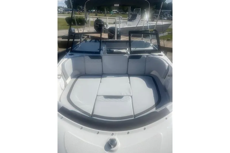 Slide: The Image of 2026 Bayliner M17 boat interior with cushioned seating and open windshield. - 13