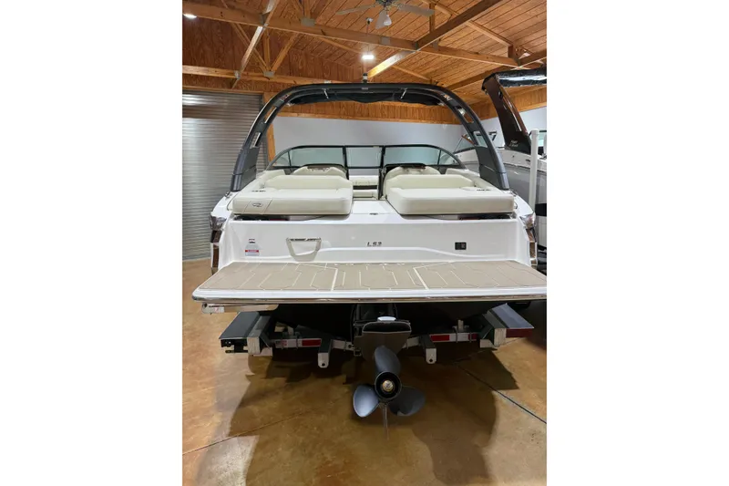 Slide: The Image of 2026 Regal LS2 boat in showroom, rear view with swim platform and propeller. - 3