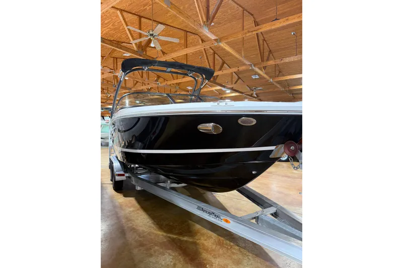 Slide: The Image of 2026 Regal LS2 boat on trailer in wooden-ceiling showroom. - 5