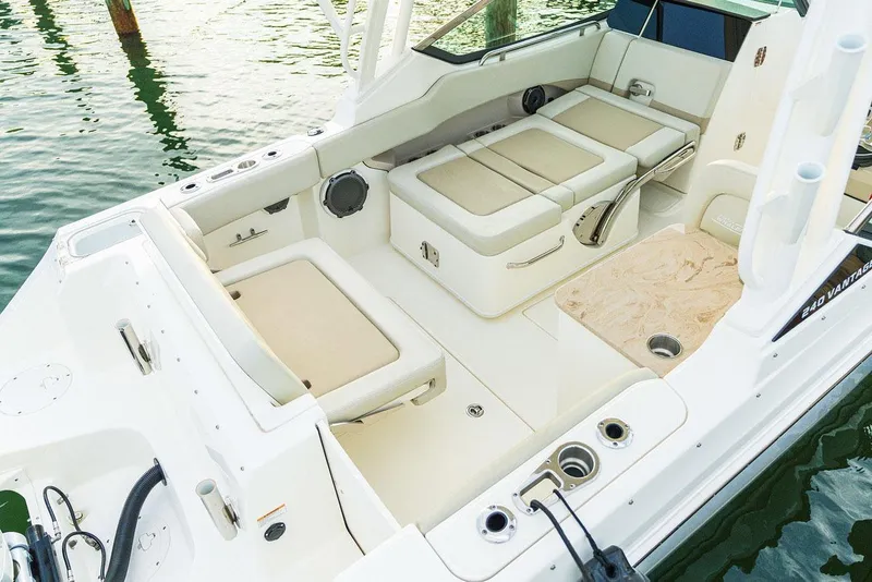 Slide: The Image of Manufacturer Provided Image: 2026 Boston Whaler 240 Vantage boat interior with beige seating and storage compartments. - 7