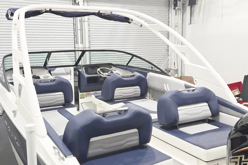 Slide: The Image of 2026 Regal LX2 boat interior with blue and white seating, sleek design, and modern features. - 10