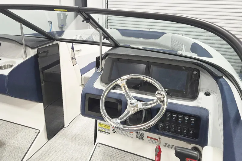 Slide: The Image of 2026 Regal LX2 boat dashboard with steering wheel and control panel. - 5