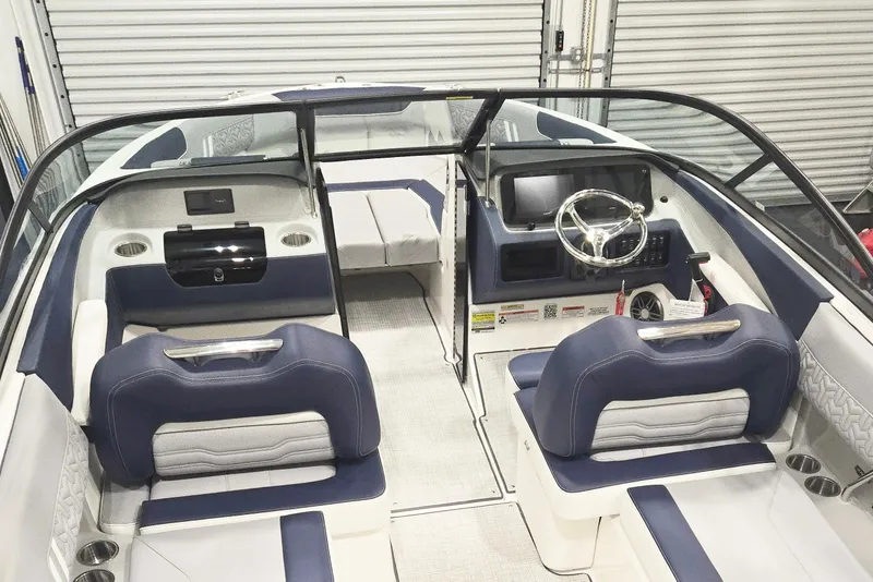 Slide: The Image of 2026 Regal LX2 boat interior with blue and white seating, modern dashboard, and steering wheel. - 7