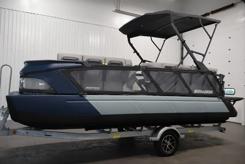 Slide: The Image of 2025 Sea-Doo Switch Cruise Limited 21 pontoon boat in a showroom setting. - 30