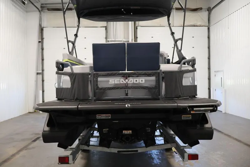 Slide: The Image of 2025 Sea-Doo Switch Cruise Limited 21 pontoon boat in a garage setting. - 3