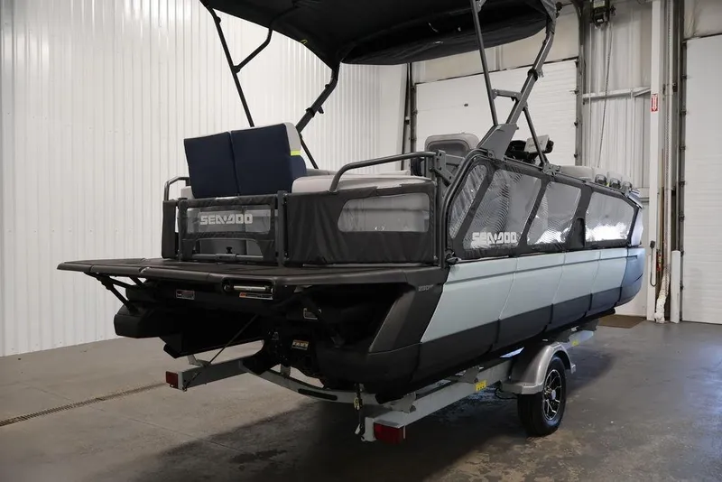 Slide: The Image of 2025 Sea-Doo Switch Cruise Limited 21 pontoon boat in indoor storage. - 29