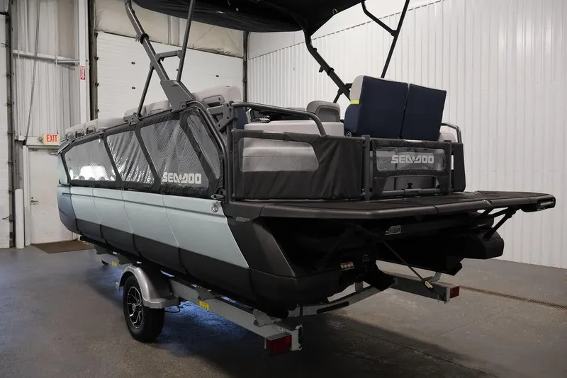 Slide: The Image of 2025 Sea-Doo Switch Cruise Limited 21 pontoon boat in a garage setting. - 18