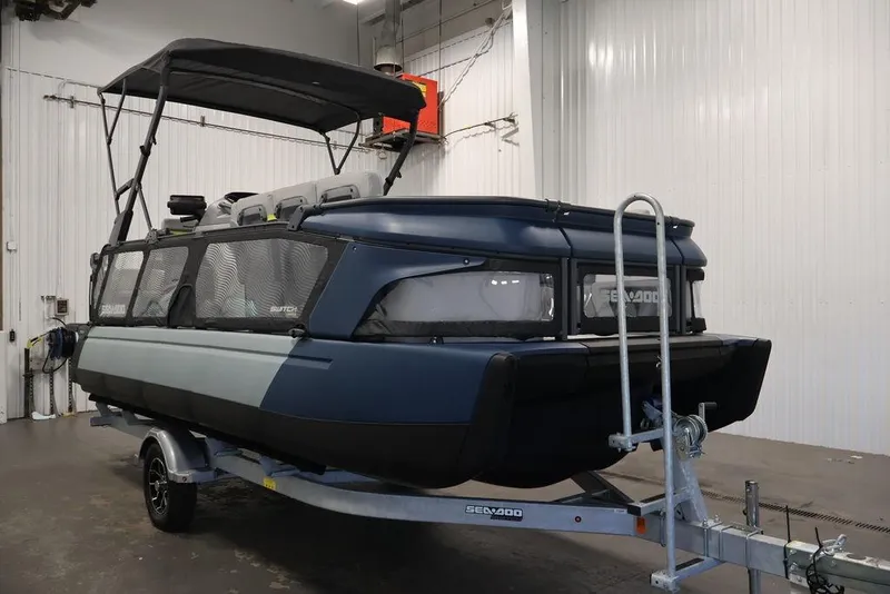 Slide: The Image of 2025 Sea-Doo Switch Cruise Limited 21 pontoon boat on trailer in indoor setting. - 1