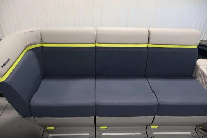 Slide: The Image of 2025 Sea-Doo Switch Cruise Limited 21 seating with blue and gray upholstery, featuring lime accents. - 28