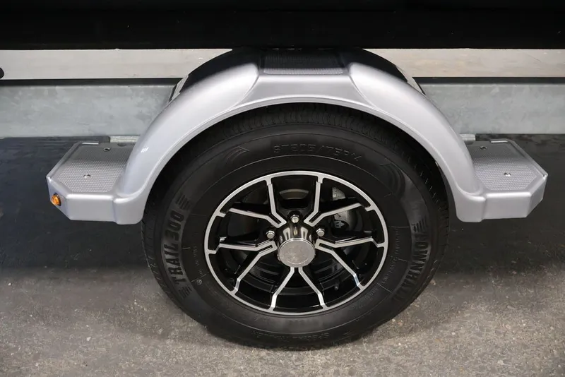 Slide: The Image of Trailer wheel of 2025 Sea-Doo Switch Cruise Limited 21, featuring sleek black alloy rim. - 14