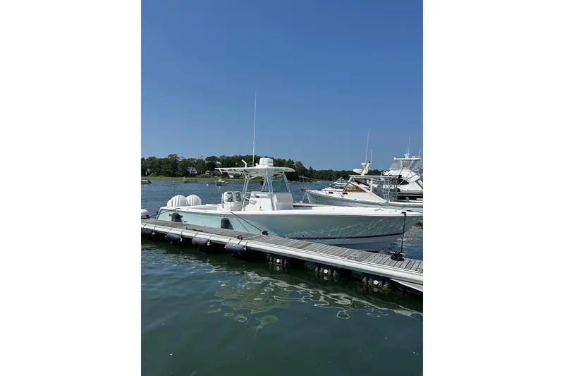 The Image of 2005 Regulator 32 Forward Seating boat docked on a sunny day. - 0