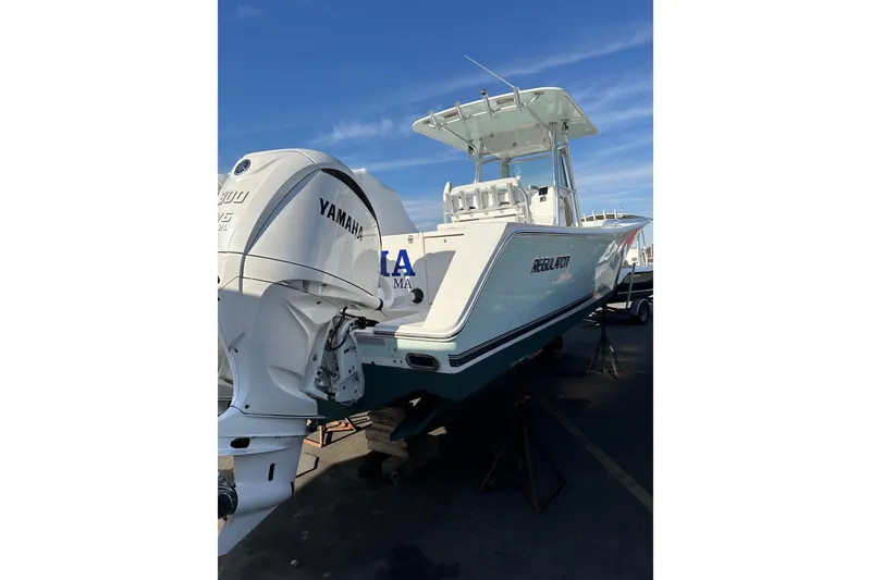 Slide: The Image of 2005 Regulator 32 Forward Seating boat with Yamaha engine, displayed outdoors. - 10