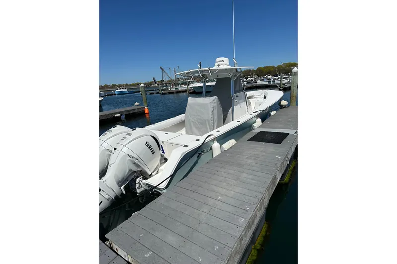 Slide: The Image of 2005 Regulator 32 Forward Seating boat docked with Yamaha engines. - 3