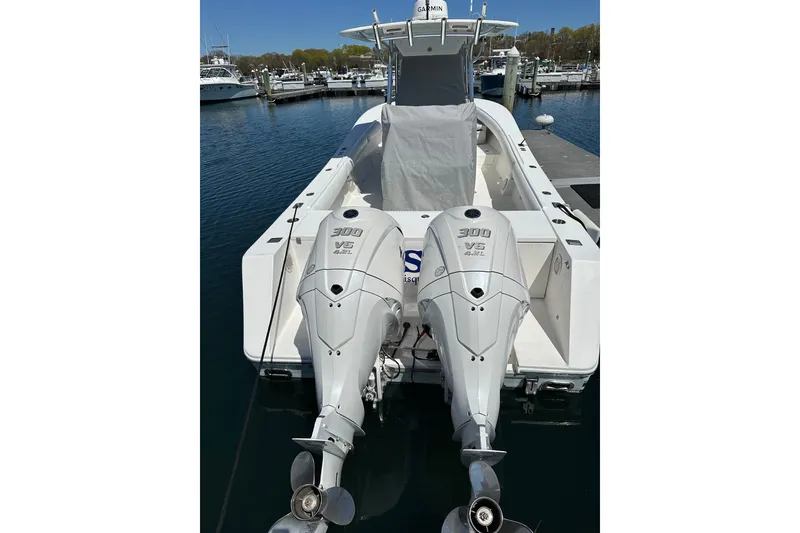 Slide: The Image of 2005 Regulator 32 Forward Seating boat with twin 300 V6 engines docked at marina. - 8