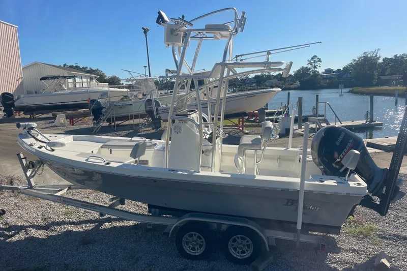 Slide: The Image of 2021 Bay Rider 219 Bay boat on trailer by waterfront dock. - 12