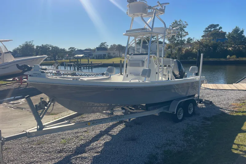 Slide: The Image of 2021 Bay Rider 219 Bay boat on trailer by a scenic waterfront. - 13