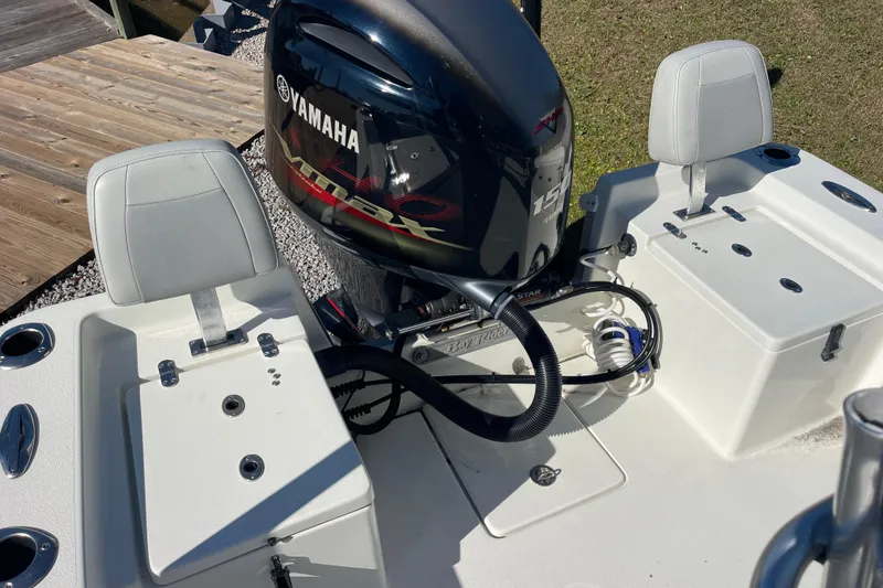 Slide: The Image of 2021 Bay Rider 219 Bay boat with Yamaha engine, featuring dual seating and storage compartments. - 14