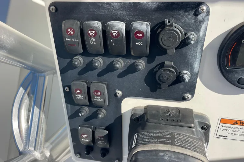 Slide: The Image of Control panel of 2021 Bay Rider 219 Bay boat with various switches and outlets. - 18
