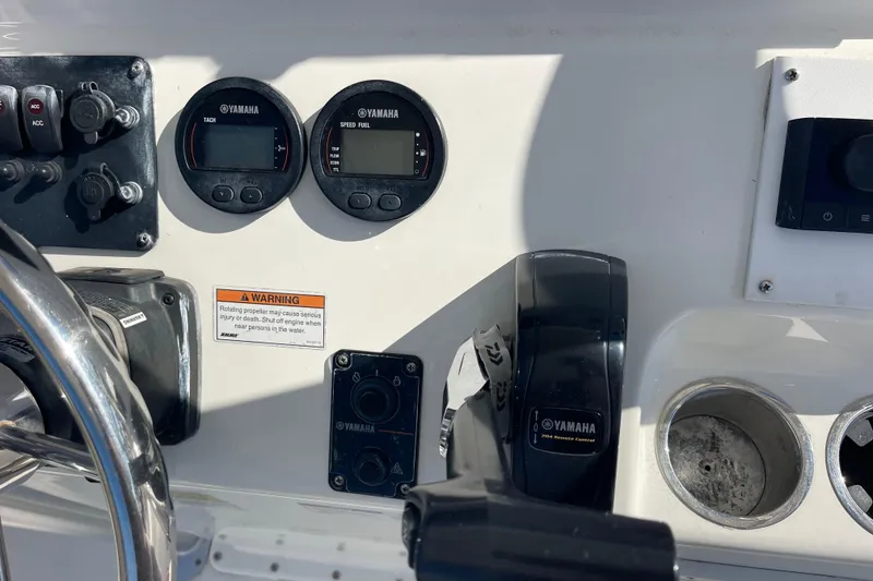 Slide: The Image of 2021 Bay Rider 219 Bay boat dashboard with Yamaha controls and gauges. - 19