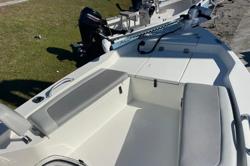 Slide: The Image of 2021 Bay Rider 219 Bay boat interior with seating and Mercury outboard motor. - 21