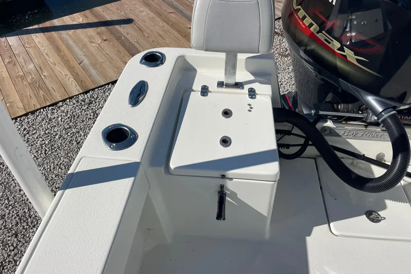 Slide: The Image of 2021 Bay Rider 219 Bay boat interior with seating and engine details. - 22