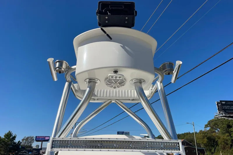 Slide: The Image of 2021 Bay Rider 219 Bay boat tower with rod holders against clear blue sky. - 26