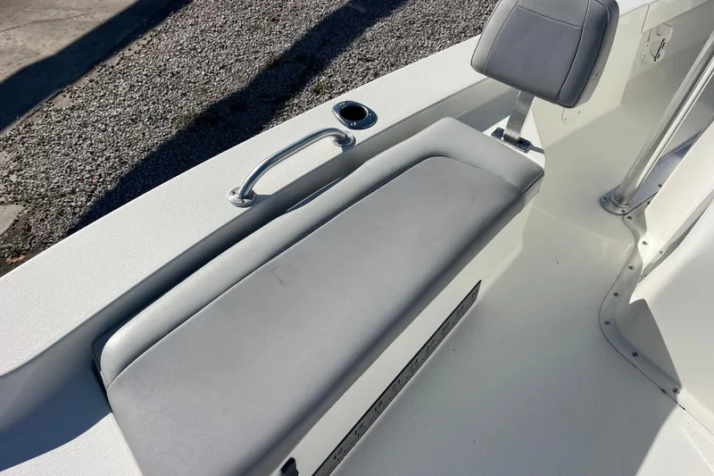 Slide: The Image of 2021 Bay Rider 219 Bay boat interior with cushioned seating and handle. - 29
