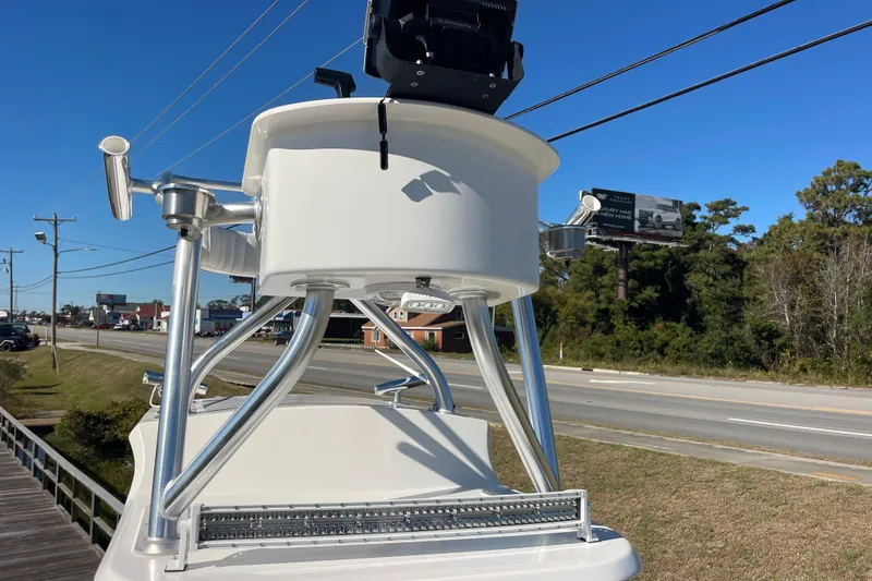 Slide: The Image of 2021 Bay Rider 219 Bay boat with T-top, parked near a road under clear blue sky. - 31