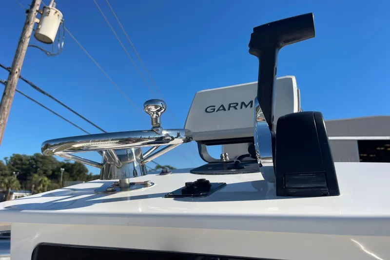 Slide: The Image of 2021 Bay Rider 219 Bay boat helm with Garmin navigation system under clear blue sky. - 32