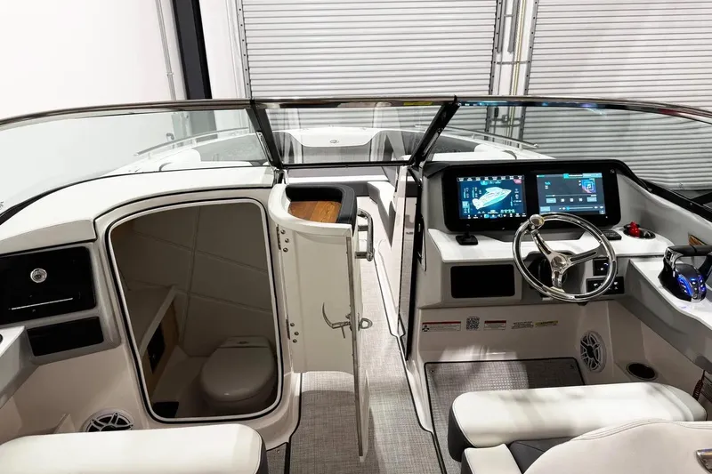 Slide: The Image of Interior of 2026 Regal LX9 boat with modern dashboard and cabin area. - 7