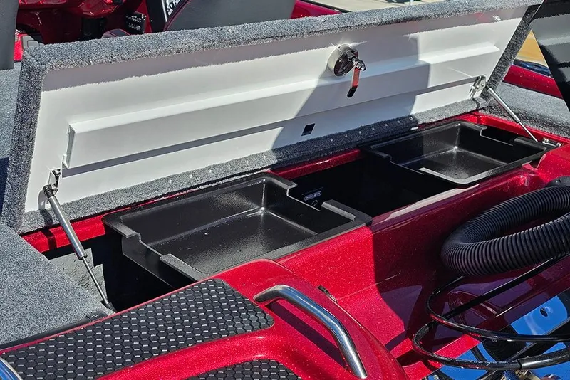 Slide: The Image of Open storage compartment in a 2026 Phoenix 819 ZXL boat, featuring dual black trays. - 11