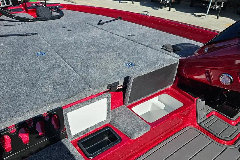Slide: The Image of 2026 Phoenix 819 ZXL boat deck with storage compartments and red trim. - 19