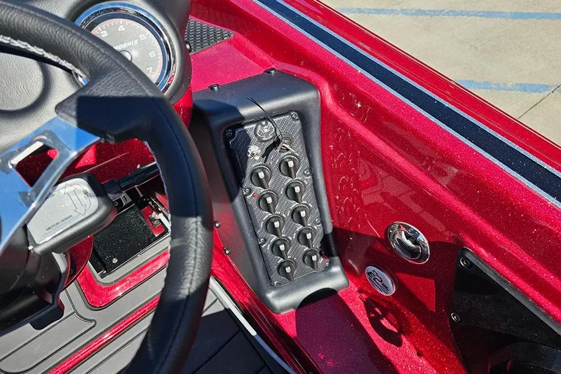 Slide: The Image of 2026 Phoenix 819 ZXL boat dashboard with steering wheel and control panel. - 24