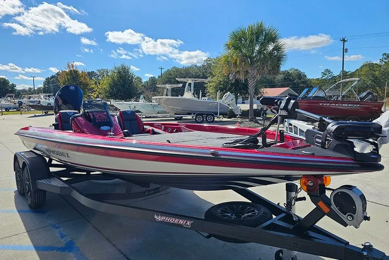 Slide: The Image of 2026 Phoenix 819 ZXL boat on trailer, parked outdoors under a clear blue sky. - 5