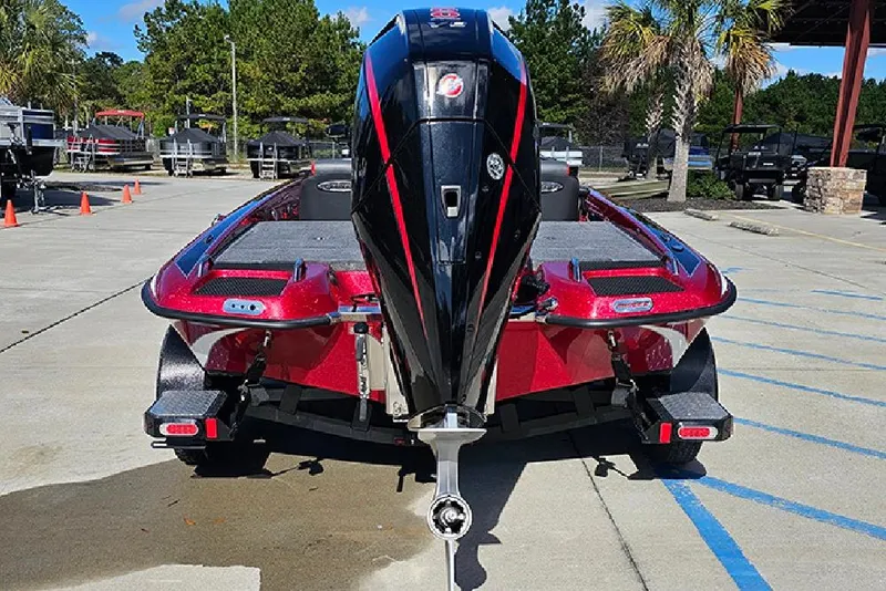 Slide: The Image of Red 2026 Phoenix 819 ZXL boat with powerful outboard motor, parked outdoors. - 8